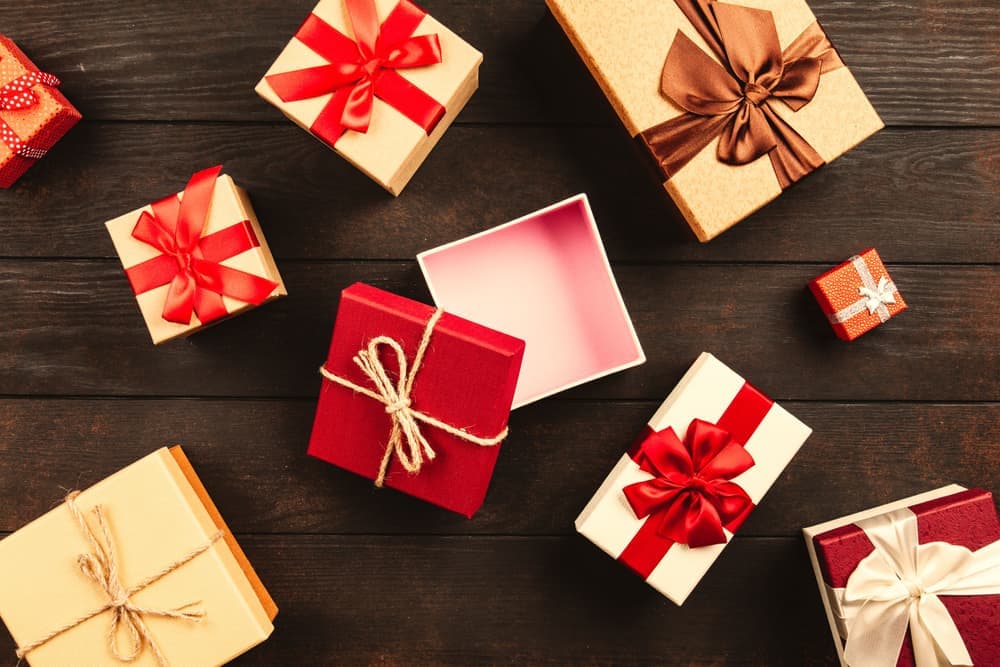 Wrapped gift boxes with ribbons on a wooden table